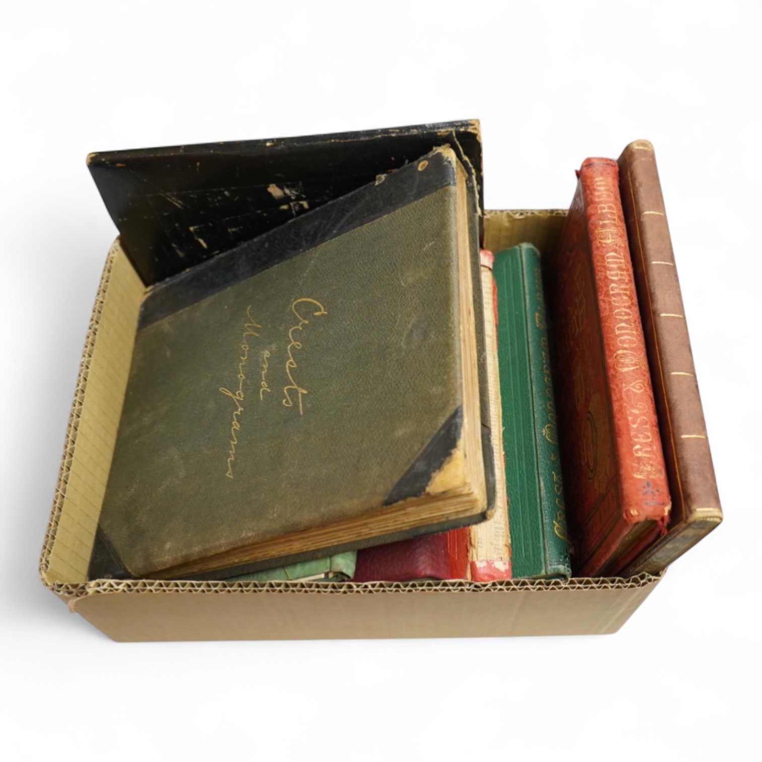 A collection of Victorian and later crest and monogram albums and loose crests and monograms